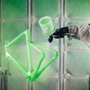 Neon green spray paint being applied to a Quintana Roo triathlon bike frame