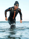 Man running out of water in HYDROfive2 wetsuit