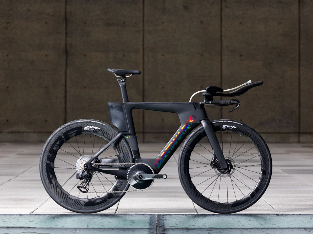 A black VPRi QR bike standing on a path, in an urban looking setting.