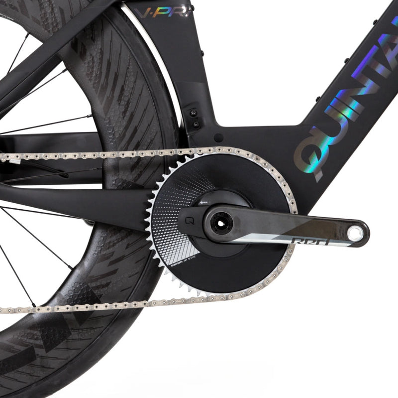 A closeup of the pedal/wheel of a black QR bike with iridescent logo lettering on a white background