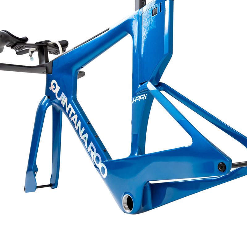A close-up of the frame of a blue Quintana Roo bicycle.