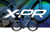 X-PR banner image with white text logo in front of a person riding an X-PR, and a smaller model in front