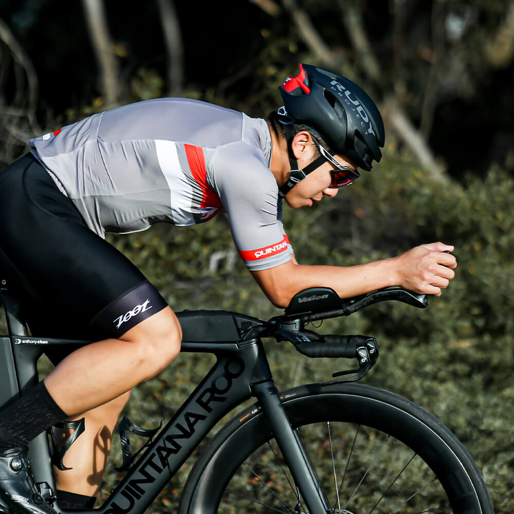 Side view of man wearing QR Jersey on bike